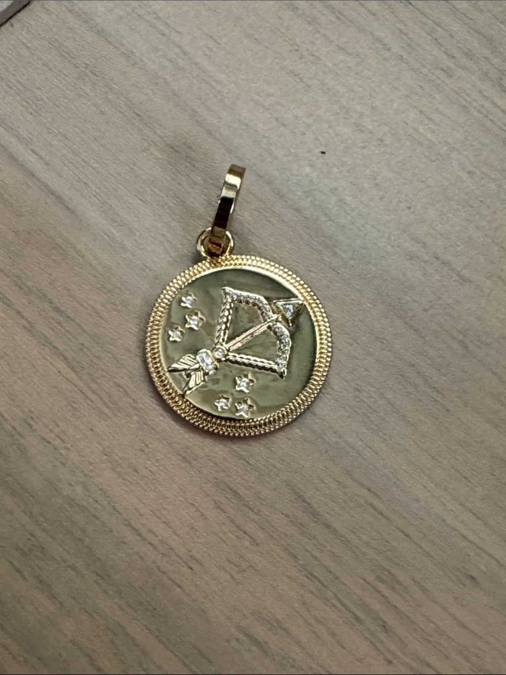 Miranda Frye gold bow & arrow charm